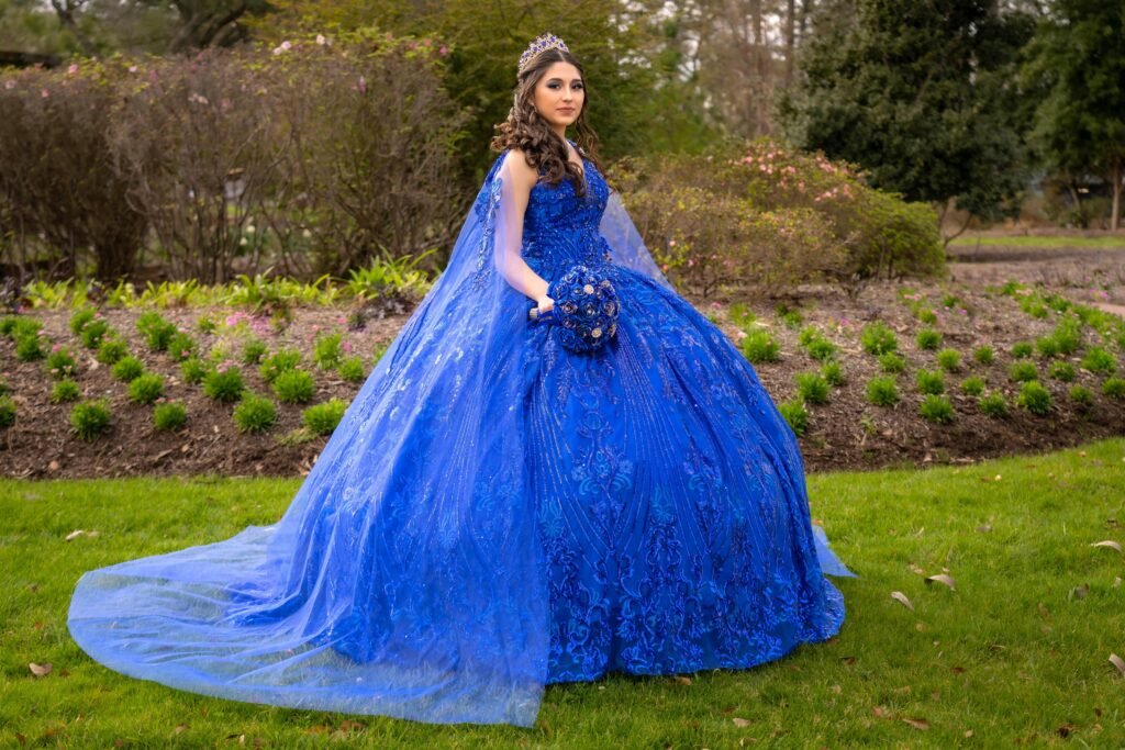 Regal woman in a luxurious blue gown in a scenic garden landscape, exuding elegance and grace.